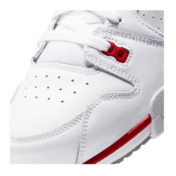 Close-up of a white Nike cross trainer shoe with red accents and lace-up closure.