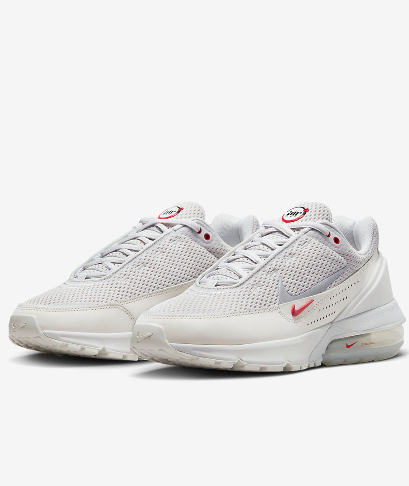 A pair of Nike Air Max Pulse sneakers in white, silver, and dusty gray, featuring a breathable mesh upper and a synthetic leather mudguard.