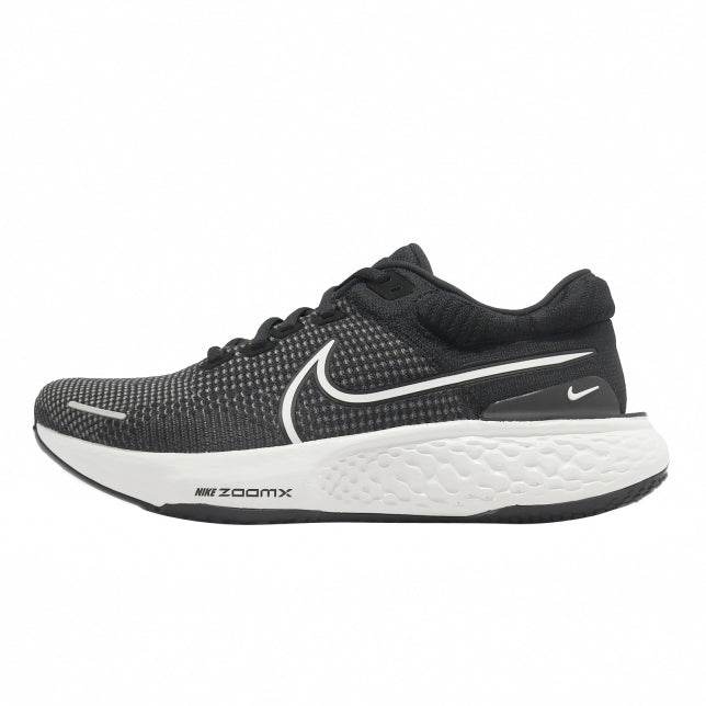 Nike ZoomX Invincible running shoes with Flyknit upper in black and white color scheme, featuring ZoomX cushioning technology.