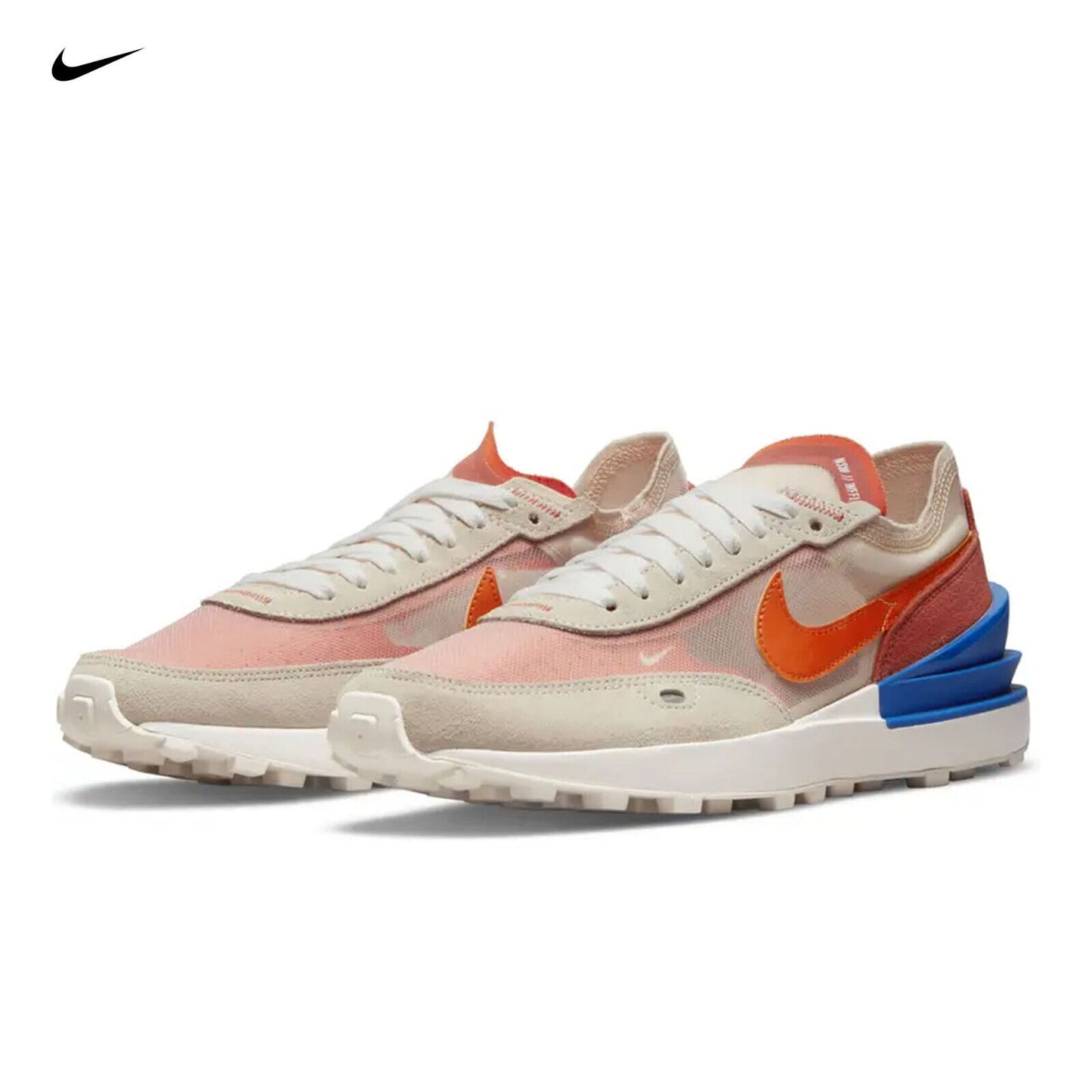 A pair of Nike Waffle One sneakers with an off-white mesh upper, orange suede accents, white cream details, and a blue plastic heel counter.