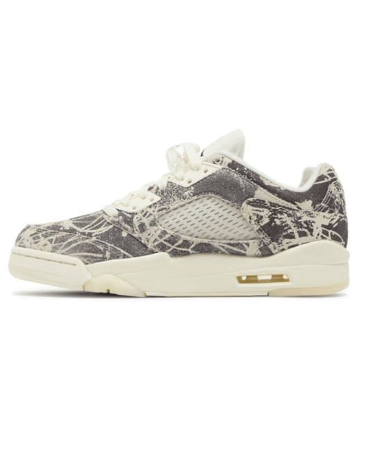 A pair of women's Air Jordan 5 Retro sneakers with a suede upper in an abstract pattern, black Jumpman logos, and a milky translucent outsole.