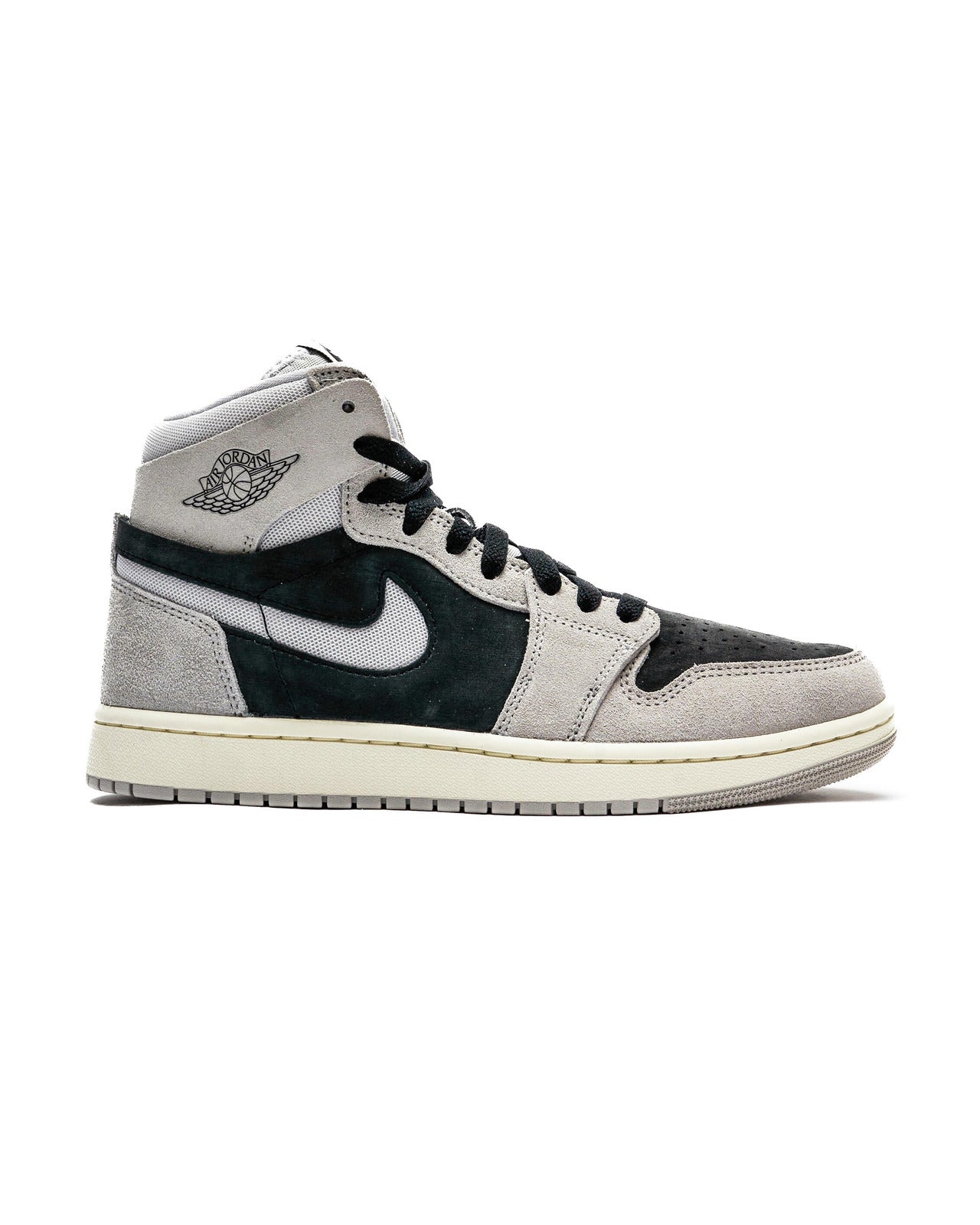 High-top Air Jordan 1 Zoom CMFT 2 sneakers with light iron ore, neutral grey, black, and coconut milk color scheme, featuring soft suede and mesh materials, iconic cut-out Swooshes, and 'Zoom Air' branding on the tongue.